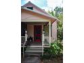 Inviting front porch with stairs, plants, and charming details on a well-maintained cottage at 748 W Florence Ave, Deland, FL 32720