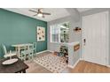Inviting dining area features green accent wall, round table and chairs, and natural light at 8445 Leeland Archer Blvd, Orlando, FL 32836
