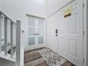 Clean entryway features wood-look floors and direct access to stairway and exterior doors at 8518 La Isla Dr, Kissimmee, FL 34747