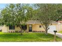 Charming single-story home with well-maintained lawn and mature trees in a tranquil setting at 10849 William Tell Dr, Orlando, FL 32821