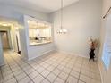 Bright dining area featuring an elegant chandelier and ceramic tile flooring, creating an ideal space for meals at 1108 Northlake Dr # 1108, Sanford, FL 32773
