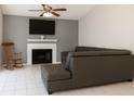 Cozy living room features a fireplace, TV, neutral paint and comfortable seating, ideal for relaxing and entertaining at 1108 Northlake Dr # 1108, Sanford, FL 32773