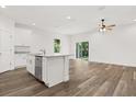 Modern kitchen featuring granite countertops, stainless steel appliances and wood grain tile at 1119 W 7Th St, Sanford, FL 32771