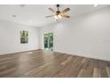 Spacious and bright living room with wood grain tile and sliding glass doors to the backyard at 1119 W 7Th St, Sanford, FL 32771