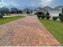Long brick driveway leads to homes in quiet suburban neighborhood at 11982 Travel Aly, Orlando, FL 32832