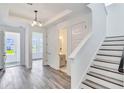 Welcoming entryway featuring modern gray floors, a staircase, and views into the living spaces at 13075 Sunrise Harvest Dr, Winter Garden, FL 34787