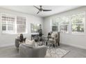 Bright home office with two large windows, a ceiling fan, and comfortable seating area with decorative rug at 141 S. Park Ave, Winter Garden, FL 34787
