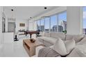 Spacious living room featuring a comfortable white sectional sofa, city views and modern decor at 150 E Robinson St # 2111, Orlando, FL 32801