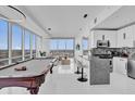 Bright living space with a pool table, modern kitchen with bar, and expansive city views at 150 E Robinson St # 2111, Orlando, FL 32801