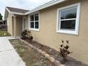 Close-up of the home's exterior, highlighting the fresh paint and manicured landscaping at 1516 Culverhouse Dr, Daytona Beach, FL 32117