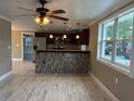 Modern kitchen featuring stainless steel appliances, dark wood cabinets, and a marble breakfast bar at 1516 Culverhouse Dr, Daytona Beach, FL 32117