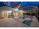 Relaxing screened-in pool with lights and ample outdoor seating at 16086 Johns Lake Overlook Dr, Winter Garden, FL 34787