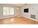 Bright living room with hardwood floors, tan walls, and window with blinds allowing natural light at 2810 Nancy St, Orlando, FL 32806