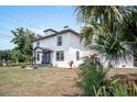 Charming two-story home with a well-manicured lawn and beautiful landscaping at 309 N Kepler Rd, Deland, FL 32724