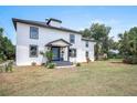 Charming two-story home with a well-manicured lawn and beautiful landscaping at 309 N Kepler Rd, Deland, FL 32724