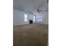 Spacious living room with fireplace, neutral walls, carpet, and ample natural light at 3124 S Semoran Blvd # 206, Orlando, FL 32822