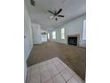 Inviting living room featuring a fireplace, neutral carpet, and ample natural lighting at 3124 S Semoran Blvd # 206, Orlando, FL 32822