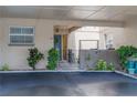 Inviting condo entrance with covered parking, lovely landscaping, and a charming blue door at 314 Windmeadows St # 314, Altamonte Springs, FL 32701