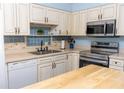 Well-maintained kitchen with stainless steel appliances and decorative tile backsplash at 314 Windmeadows St # 314, Altamonte Springs, FL 32701