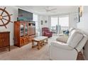 Comfortable living room with a large window and sliding glass door to balcony at 3360 Ocean Shore Blvd # 4050, Ormond Beach, FL 32176