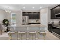 Modern kitchen features granite countertops, stainless steel appliances, and a spacious island with bar seating at 3569 Dahlia Dr, Lake Hamilton, FL 33851