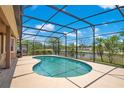 Screened-in pool area with an in-ground pool and beautiful views of the water and sky at 4047 Lillian Hall Ln, Orlando, FL 32812
