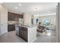 Open-concept kitchen featuring stainless-steel appliances and granite countertops, seamlessly connected to the living spaces at 4125 Lavender Ct, Lake Hamilton, FL 33851