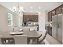Well-lit kitchen boasting granite countertops, modern stainless-steel appliances, and ample cabinet space at 4125 Lavender Ct, Lake Hamilton, FL 33851