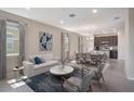 Bright living room featuring tile flooring, comfortable seating, and seamless flow into the dining area at 4125 Lavender Ct, Lake Hamilton, FL 33851