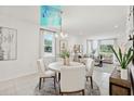 Bright dining area open to living space, featuring modern lighting and stylish furnishings at 4140 Lavender Ct, Lake Hamilton, FL 33851