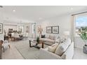 Spacious open-concept living area with dining and kitchen views, featuring stylish décor and natural light at 4140 Lavender Ct, Lake Hamilton, FL 33851