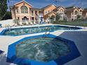 Inviting community pool and jacuzzi offer a refreshing escape, perfect for relaxation and socializing at 8704 Knightsbridge Ct # B, Kissimmee, FL 34747