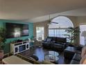 Spacious living room features large windows, high ceilings, a modern entertainment center and comfortable leather seating at 8704 Knightsbridge Ct # B, Kissimmee, FL 34747