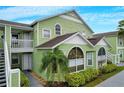 Charming condo building with light green exterior and white trim at 8719 Rockingham Ter # B, Kissimmee, FL 34747