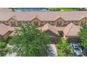 An aerial view displays the property's prime location near a serene pond and well-maintained community grounds at 10430 Belfry Cir, Orlando, FL 32832