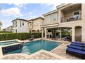 Inviting pool and patio area, with a spa, lounge chairs, and an outdoor dining set, perfect for relaxation and entertaining at 1084 Castle Pines Ct, Reunion, FL 34747