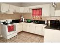 Functional kitchen featuring tile countertops and essential appliances at 1181 Partlow Dr, Winter Garden, FL 34787