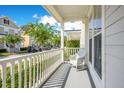 Inviting front porch featuring a comfortable rocking chair with views of a quiet street at 1222 Golden Canna Ln, Celebration, FL 34747