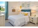 Bright bedroom with surf-themed decor, a large window, and light-colored walls and furnishings at 152 Fredericksburg Ave, Orange City, FL 32763