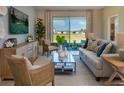 Comfortable living room featuring neutral tones, a large sliding glass door, and stylish furnishings at 152 Fredericksburg Ave, Orange City, FL 32763