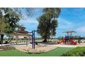 Community playground with swings, slides, a gazebo, and a soft play surface surrounded by green space at 152 Fredericksburg Ave, Orange City, FL 32763