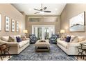 Bright living room with a ceiling fan, neutral tones, and stylish furnishings at 1600 N Wind Ct, Winter Springs, FL 32708