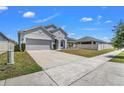Charming one-story home featuring manicured lawn, two-car garage and a nice driveway at 1821 Benevento St, St Cloud, FL 34771