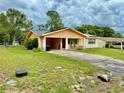 Classic one-story home boasts a covered carport and lush green lawn at 2 Clear Pl, Ocala, FL 34472