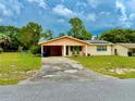 Charming one-story home features a covered carport and a well-maintained front lawn at 2 Clear Pl, Ocala, FL 34472