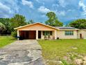 Inviting one-story home with carport, featuring a well-kept lawn and classic design at 2 Clear Pl, Ocala, FL 34472