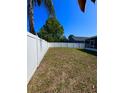 Spacious fenced-in backyard, perfect for outdoor activities and pets, featuring a well-maintained lawn at 2049 Crosscreek Ct, Oviedo, FL 32766
