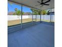 Relaxing screened lanai with a ceiling fan overlooking the backyard and the white fence at 2049 Crosscreek Ct, Oviedo, FL 32766