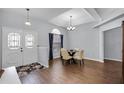 Formal dining area boasts wood floors, chandelier, and a view from the front door at 2203 Essex Dr, Ocoee, FL 34761