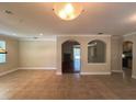 Spacious living room with tile flooring and arched openings to other rooms at 2585 Woodside Ridge Dr, Apopka, FL 32712